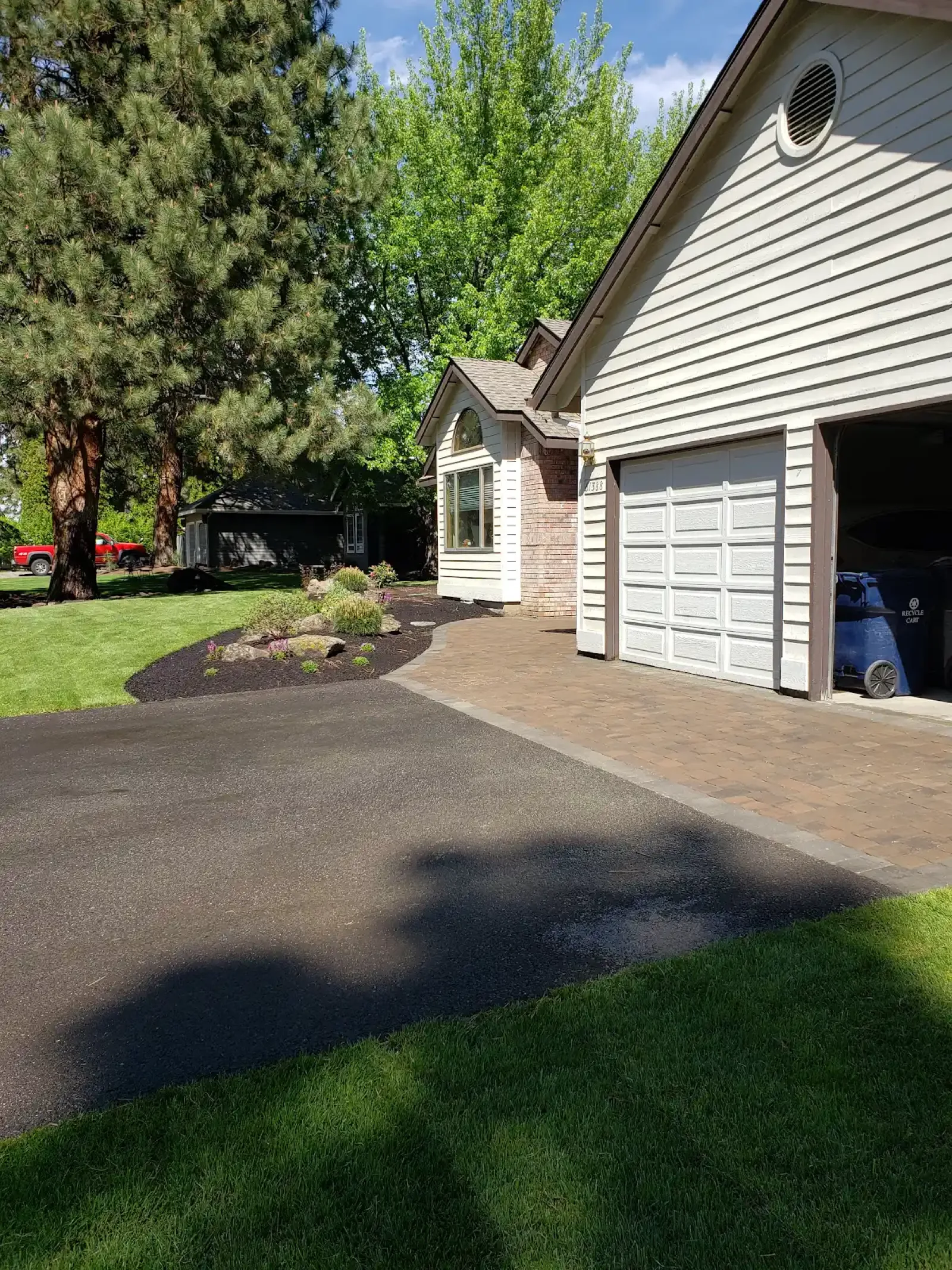 Paver driveway extension with green lawn