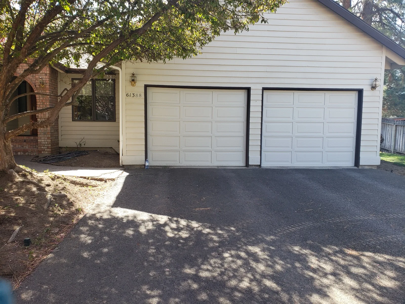 Front of house with bare dirt beds