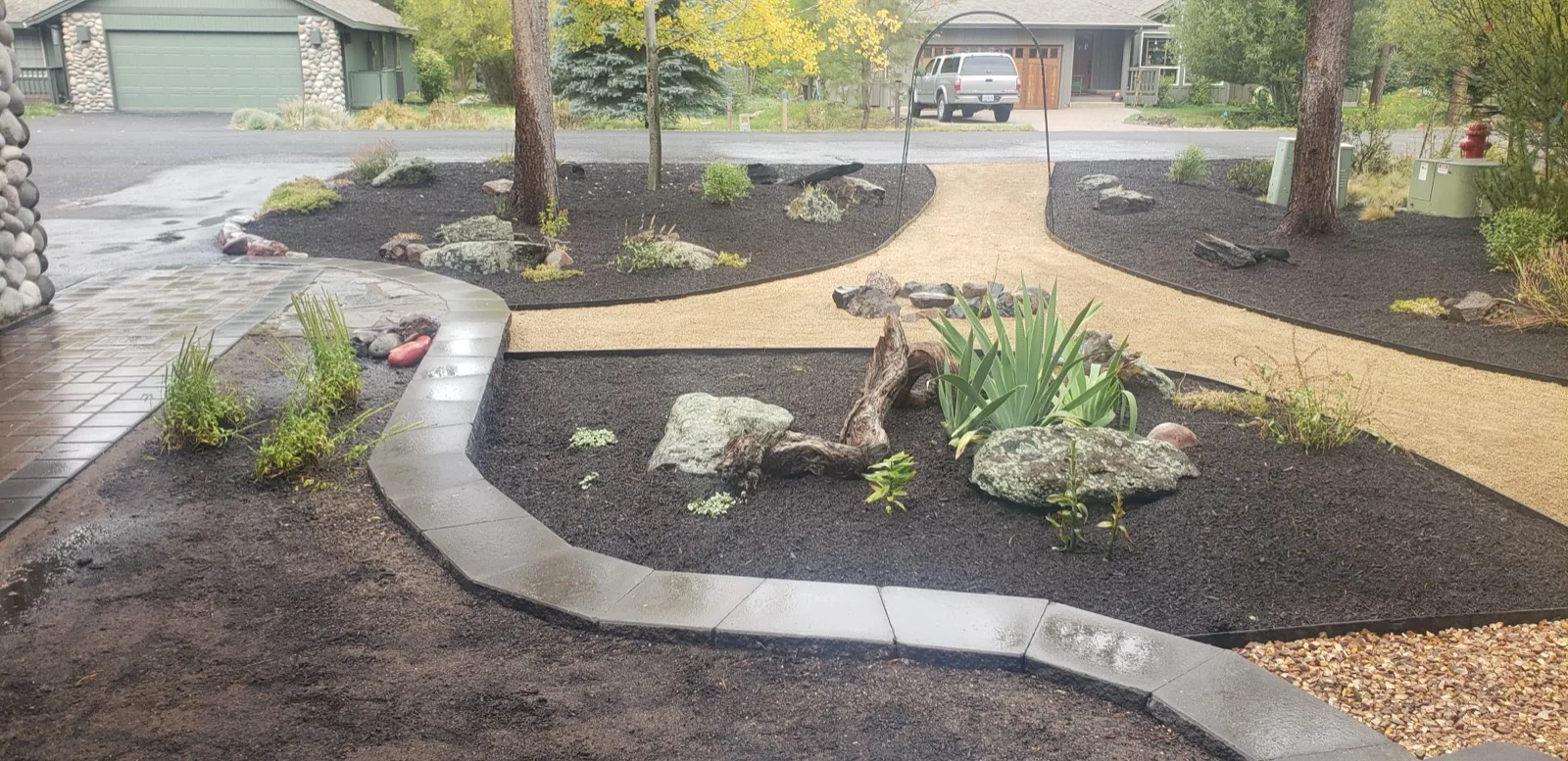 Finished yard with mulch, gravel paths, and paver edging