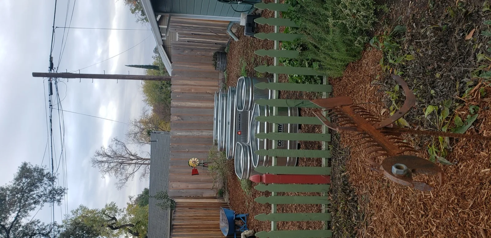 Galvanized stock tank raised garden beds with mulch base — a practical and stylish growing setup.